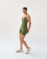 Side view of green Corset Bodysuit with anti-camel toe design, showcasing faux-corset underbust and princess seams for a flattering fit.