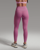 Person wearing a pink athletic outfit on a gray background