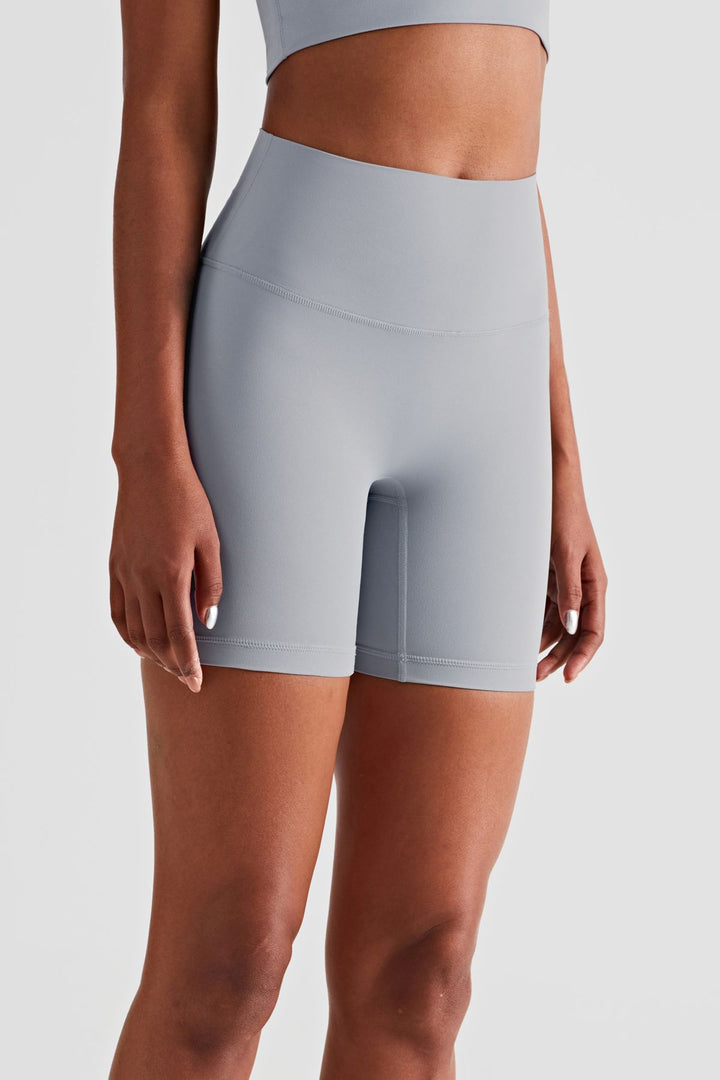 Female model posing in premium Grey high waisted and squat proof bike shorts suitable for yoga, running, dancing, gym and athletic activities
