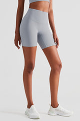 athletic female model posing in premium Grey high waisted and squat proof bike shorts suitable for yoga, running, dancing, gym and athletic activities