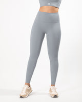 Female model posing in grey leggings suitable for workout with a high waist and squat-proof fit, perfect for any athletic activity