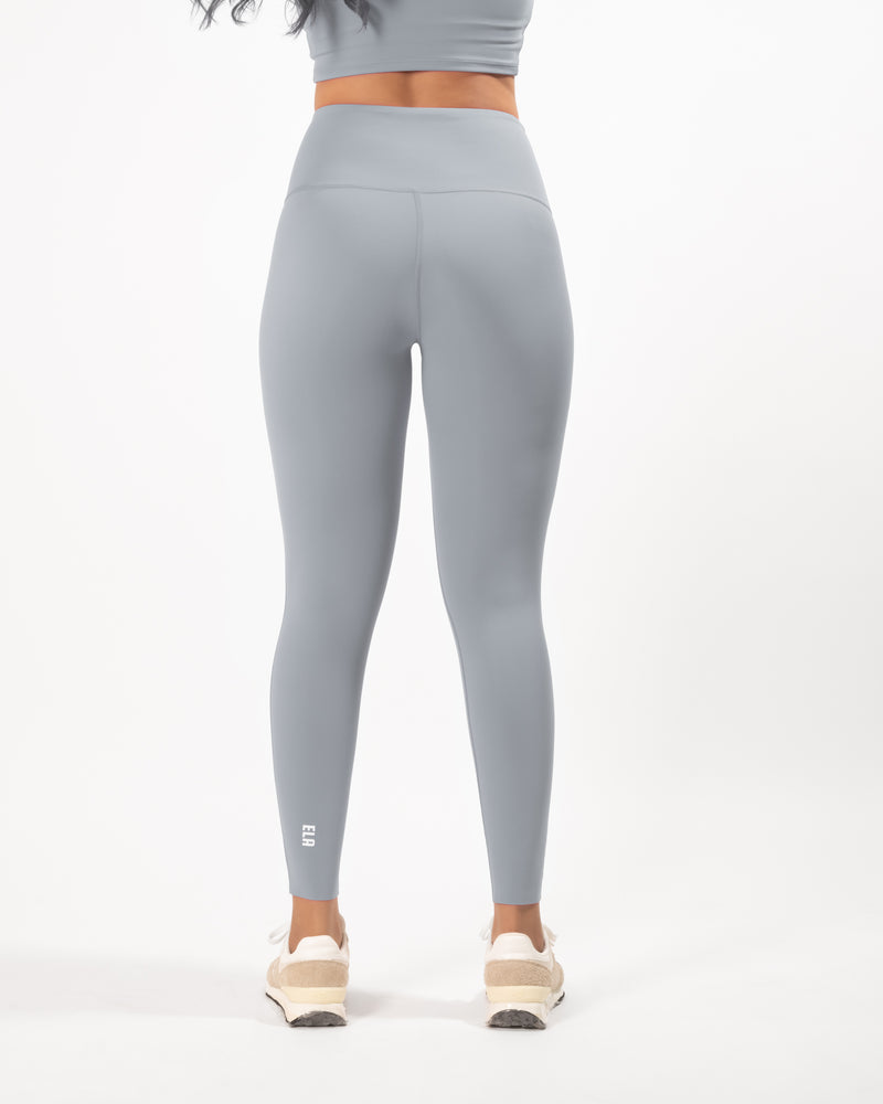 Female model posing in grey leggings with a high waist and squat-proof fit, perfect for any workout or athletic activity