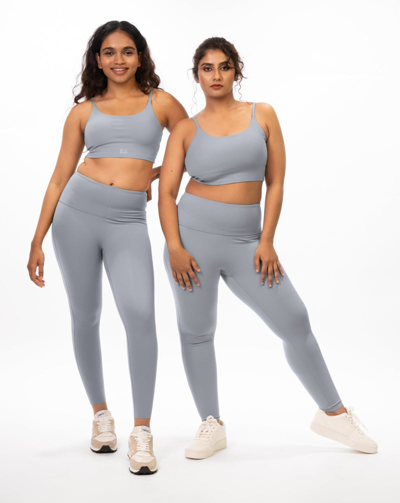 Female models posing in matching grey sports bra and leggings, showcasing the coordinated activewear set on different body types that is suitable for gym and yoga