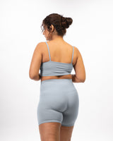 plus size Female model posing in premium Grey high waisted and squat proof bike shorts with matching sports bra. The co-ordinated activewear set is best for yoga, running, dancing, gym and athletic activities