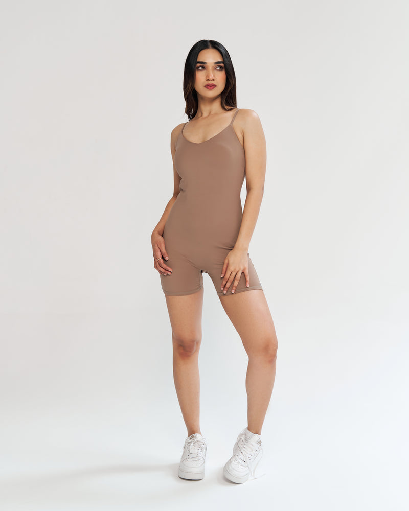 Neutral vibes with our nude playsuit - a body-hugging fit for the modern woman. Seamless front, soft neckline, and adjustable spaghetti straps for personalized comfort. Full support with a built-in shelf bra. Quick Drying, 4 Way Stretch, Lightweight & Breathable