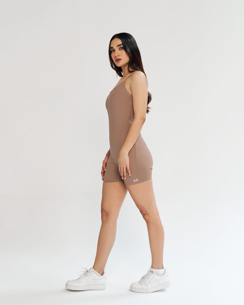 Nude perfection! Our playsuit in a soft, neutral shade hugs your curves, providing comfort and style. Seamless front, soft neckline, and adjustable spaghetti straps for your ideal fit. Full support with a built-in shelf bra. Quick Drying, 4 Way Stretch, Lightweight & Breathable