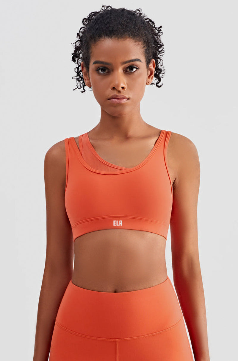 female model wearing orange sports bra with built-in padding for extra support for high intensity workout. the bra is suitable for gym, yoga or any athletic activities