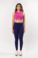 female model in a fuschia pink high neck sports bra and purple blue legging, showcasing the coordinated activewear set for workout
