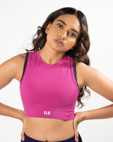 female model wearing fuschia pink high neck sports bra made for gym and workout