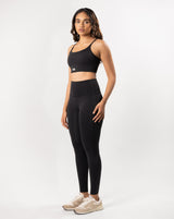 Female Model posing in black activewear set including a sports bra that is suitable for high impact workout and high-wiasted gym leggings perfect for any workout or athletic activity.