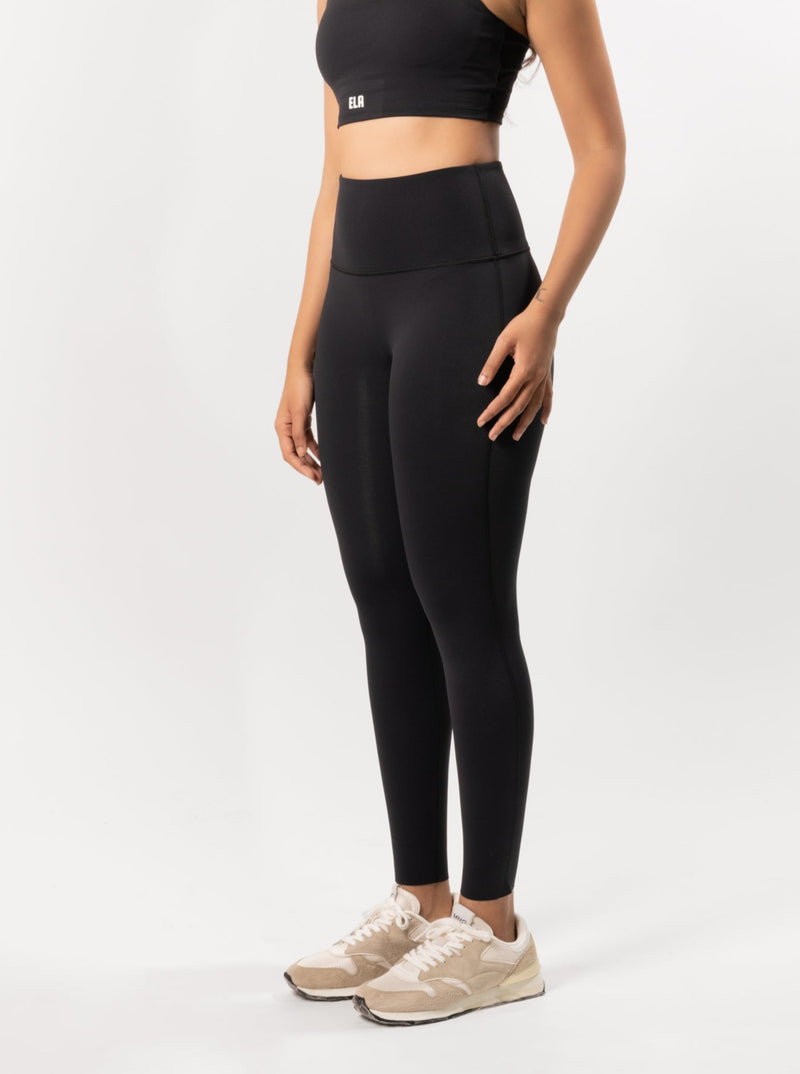 Female model posing to display Black buttery smooth leggings that is suitable for gym, yoga and other workout activities