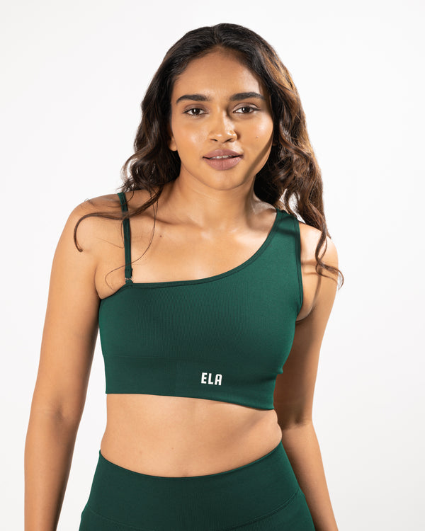 Model wearing a one shoulder strap sports bra with an optional detachable second strap, suitable for a variety of workout activities.