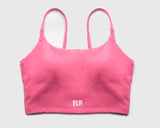 Flatlay image of a pink sports bra with internal structure of built-in bra pads for maximum support during high intensity workout