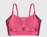 Flatlay image of a pink sports bra with internal structure of built-in bra pads for maximum support during high intensity workout