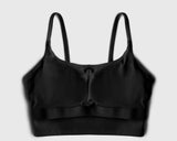 Flatlay image of a black sports bra with internal structure of built-in bra pads for maximum support during high intensity workout
