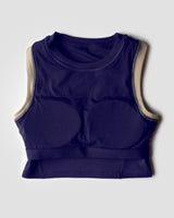 Flatlay image of purple blue high neck sports bra showing internal structure of built-in pads for maximum support during workout