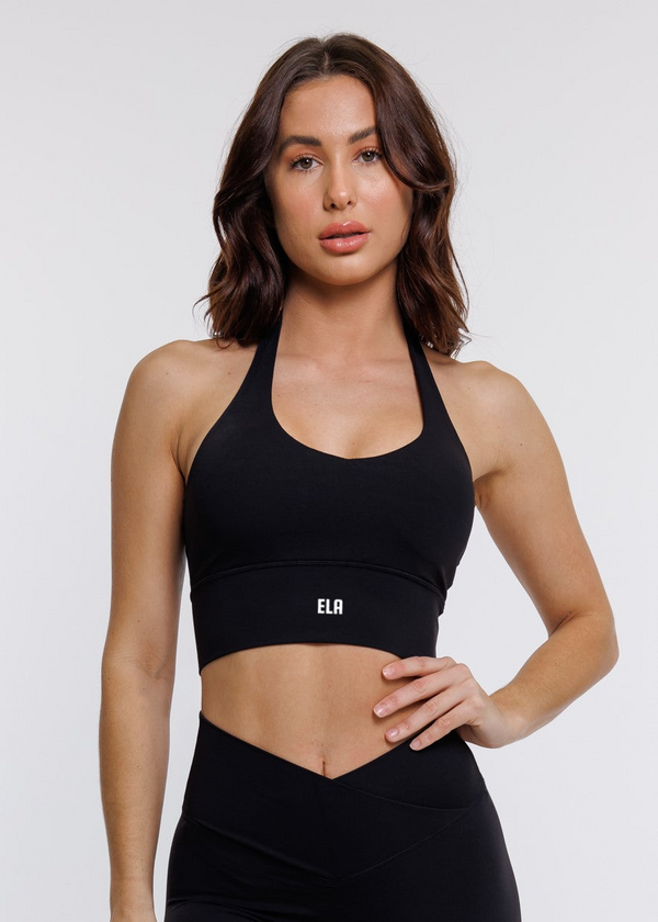 female model in black halter neck sports bra suitable for variety of athletic activities, gym, yoga and workout.
