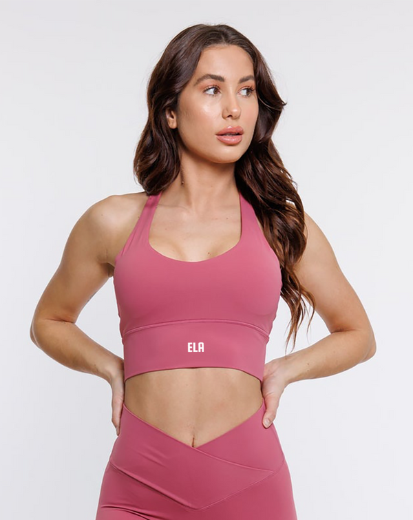 female model in pink halter neck sports bra suitable for variety of athletic activities, gym, yoga and workout.