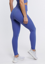 A female model wearing the ButterBod Hourglass Leggings, highlighting close up of legging. The high-waisted wrap design and V-cut waistband accentuate her curves, while the booty-lifting back seam provides a flattering lift. The leggings have a soft matte finish, medium compression, and are made from 4-way stretch fabric for maximum comfort and versatility.